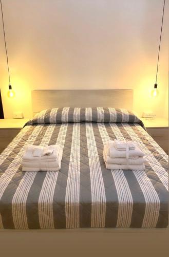 a bed with two towels on top of it at Casa Antonella in Castel Gandolfo