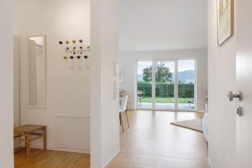 a white living room with a table and a door at Auszeit am Wiehengebirge in Bad Essen