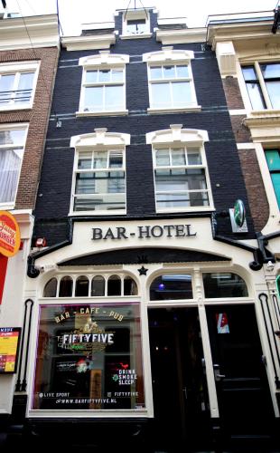 a bar building with a bar hotel on a street at Hotel 55 - City Centre in Amsterdam
