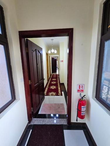 a hallway with a fire extinguisher in a room at Blue Rawal in Bain Boeuf
