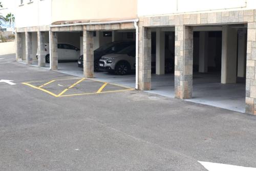 a parking lot with two cars parked in it at Beachfront, First line, 2-Bdr,2-Bath, Swiming Pool in Albir