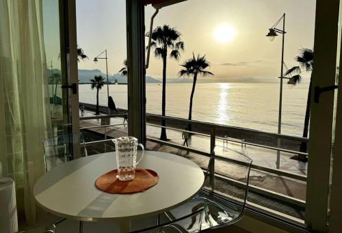 a glass vase sitting on a table in front of a window at Beachfront, First line, 2-Bdr,2-Bath, Swiming Pool in Albir