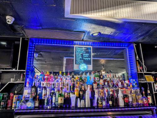 a bar filled with lots of bottles of alcohol at Fairmount Inn & Suites - Stroudsburg, Poconos in Delaware Water Gap