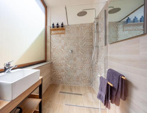 a bathroom with a sink and a shower at My tiny lovely house in Civitavecchia