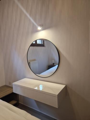 a bathroom with a mirror and a white sink at MELATO HOUSES in Valtessiniko 