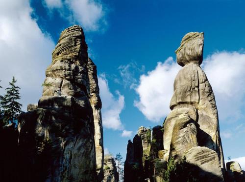 a rock formation in front of a blue sky at Penzion U Karabiny in Adršpach