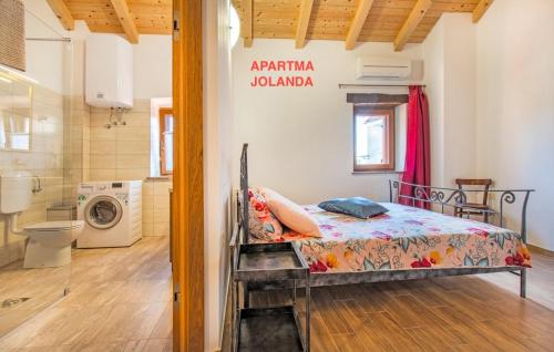 a bedroom with a bed and a washing machine at Apartma Jolanda in Šmarje