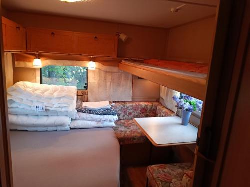 a small room with two bunk beds and a table at Santa's winter Caravan-Kabe Royal in Rovaniemi