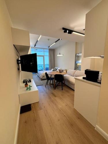 a living room with a couch and a table at Brand New Studio - Comfy & WFH in Dubai