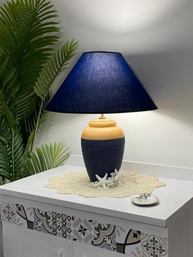 a blue lamp sitting on top of a table at Via Roma 55 in Lipari