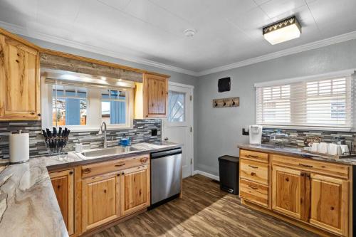 a kitchen with wooden cabinets and stainless steel appliances at Close to Hiawatha Tr and Biking with HOT TUB in Wallace