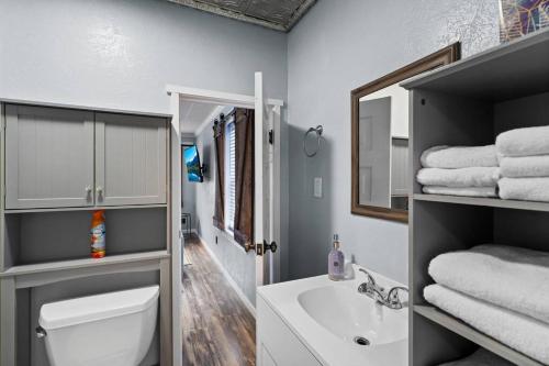 a bathroom with a toilet and a sink and a mirror at Close to Hiawatha Tr and Biking with HOT TUB in Wallace