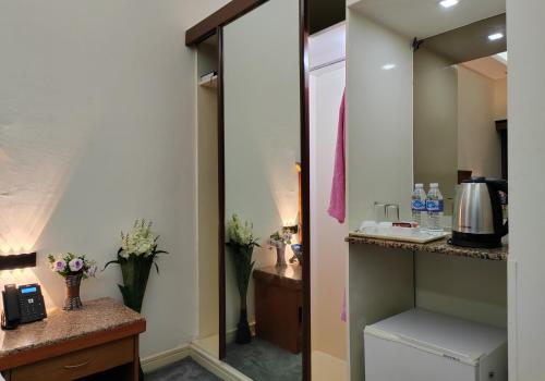 a bathroom with a sink and a mirror at Le Paradise Palace Hotel Deira Dubai Al Rigga in Dubai