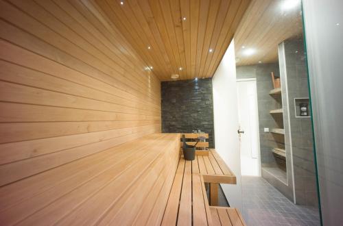 a hallway with a wood paneled wall at Santa's winter Caravan-Kabe Royal in Rovaniemi