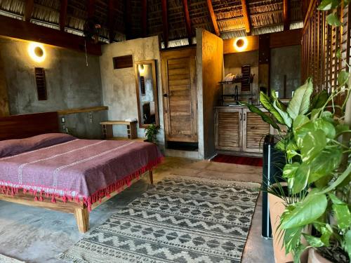 a bedroom with a bed in a room with a rug at Casa Monika in Puerto Escondido