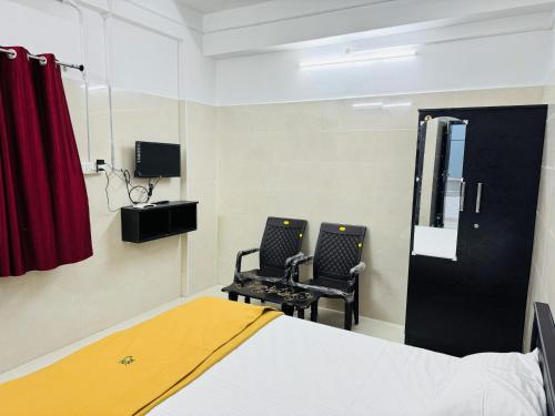 a hospital room with two chairs and a bed at MSResidency in Golden Rock