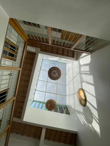 a room with a ceiling with a glass window at Riad Madinina in Marrakech