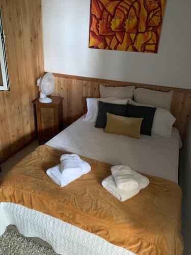 a bedroom with a bed with two towels on it at SERMAR 1 in Rabo de Peixe