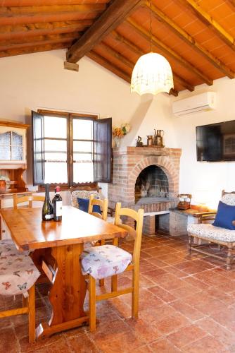 a living room with a wooden table and a fireplace at Borgo Il Poggio Agriturismo in Montaione