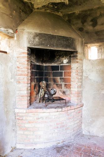 a brick brick oven with a fire in it at Borgo Il Poggio Agriturismo in Montaione