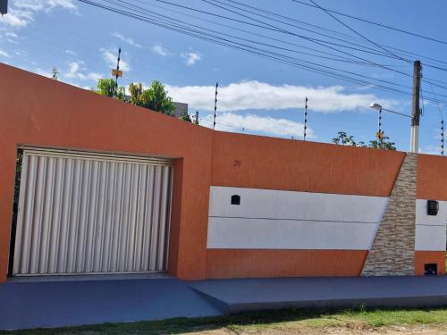 two garage doors on the side of a building at CASA de PRAIA NO FRANCÊS 3 QUARTOS SENDO 1 SUITE in Marechal Deodoro