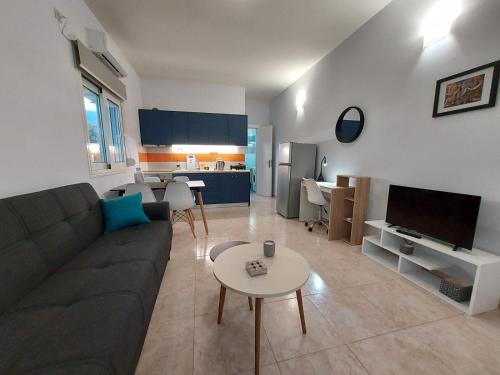 a living room with a couch and a table at Oresti's House in Loutraki