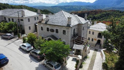 una casa grande con coches estacionados frente a ella en Konstantinou & Elenis, en Monodendri
