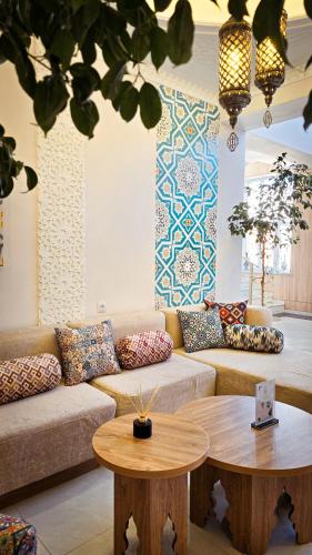 a living room with a couch and a table at Hotel Bankir Khiva in Khiva