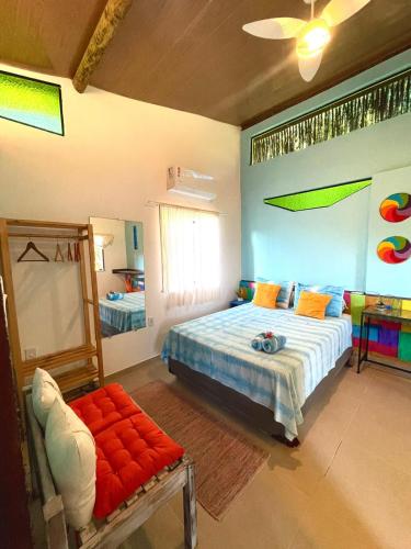 a bedroom with a bed and a chair in it at Vila Entreluas in Morro de São Paulo