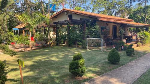 a house with a yard with a soccer goal at Chalés Senhor Dos Trilhos in Mairiporã
