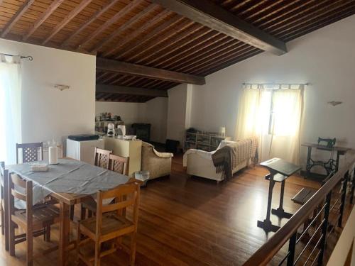 a living room with a table and a couch at Sermar in Rabo de Peixe