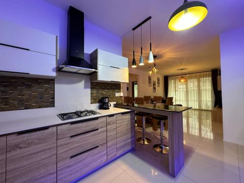 a kitchen with white cabinets and a stove top oven at SeaSand-Entire Luxury 3 BD condo - Close to beach in Flic-en-Flac