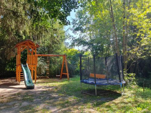 a park with a swing set and a playground at Las i Staw Roztocze in Wólka Łosiniecka