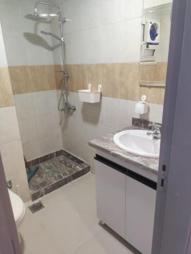 a bathroom with a sink and a shower and a toilet at Sunny Dahab Resort Family Deluxe in Dahab