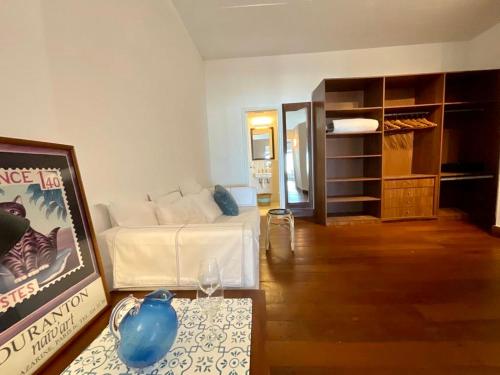 a living room with a white couch and a table at La Posta Beach Hotel in Punta del Este