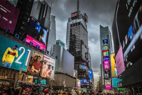 a busy city street with tall buildings and billboards at Tonel Paradise 1BR private entrance Near JFK in Rosedale