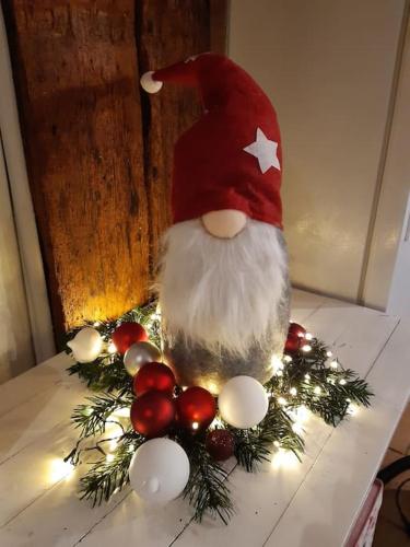 a santa claus figurine sitting on a table at Ferme de Chenezeau - 15 personnes , 7 chambres in Gérardmer