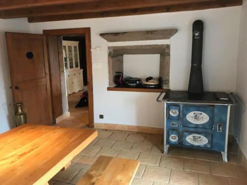 a room with an old stove in a room at Ferme de Chenezeau - 15 personnes , 7 chambres in Gérardmer