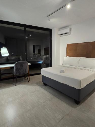 a bedroom with a bed and a table and a desk at 216-Koi living Ballito in Ballito