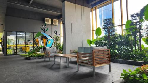 a patio with chairs and a table in a building at Opus Residences Kuala Lumpur by Infini Suites in Kuala Lumpur