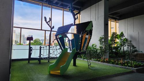 a playground in a building with a slide at Opus Residences Kuala Lumpur by Infini Suites in Kuala Lumpur