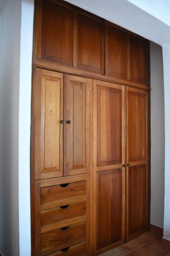 a closet with wooden cabinets in a room at Zihil Ha Hotel in Playa del Carmen