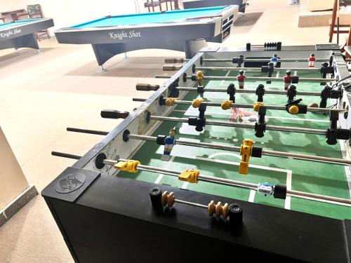 a row of pool tables in a room at Nomad Partition Room in Barsha Heights 3 mins to ICM Metro in Dubai