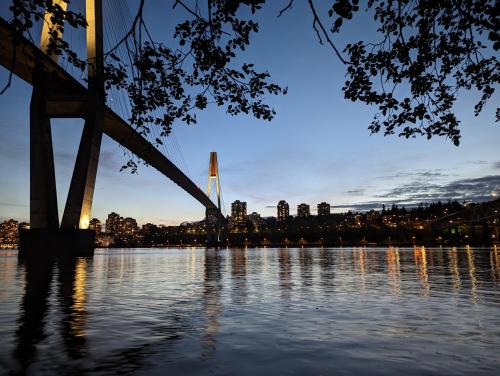 a bridge over the water with a city in the background at Angela's Private Suites in Surrey