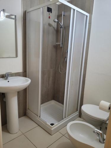 a bathroom with a shower and a toilet and a sink at Alice Apartments in Crescentino