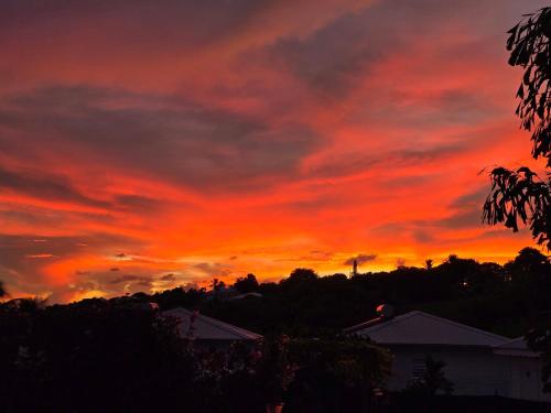 a sunset with a red and orange sky at Eden Lodge 4 Villas avec piscine privée in Saint-François