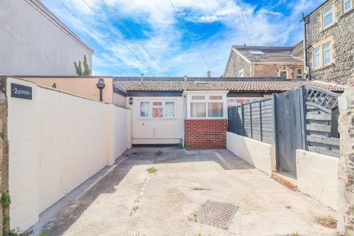 a house with a white fence and a garage at Clifton Sands in Weston-super-Mare
