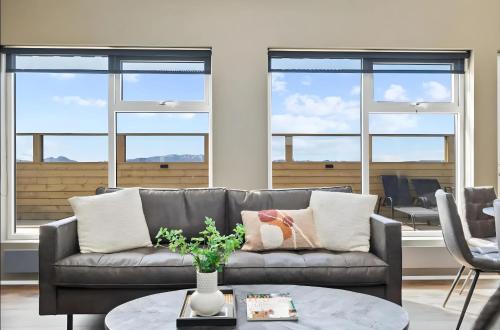 a living room with a couch and a table at Cozy Cabin with Hot Tub & Sauna - Ultimate Retreat in Veiðilundur