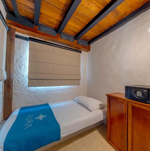 Ένα ή περισσότερα κρεβάτια σε δωμάτιο στο Aura Hotel Barú