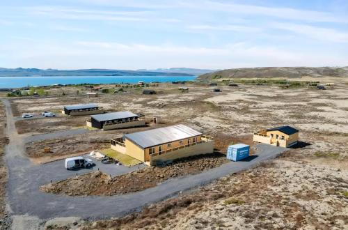 an aerial view of two buildings in a field at Cozy Cabin with Hot Tub & Sauna - Ultimate Retreat in Veiðilundur